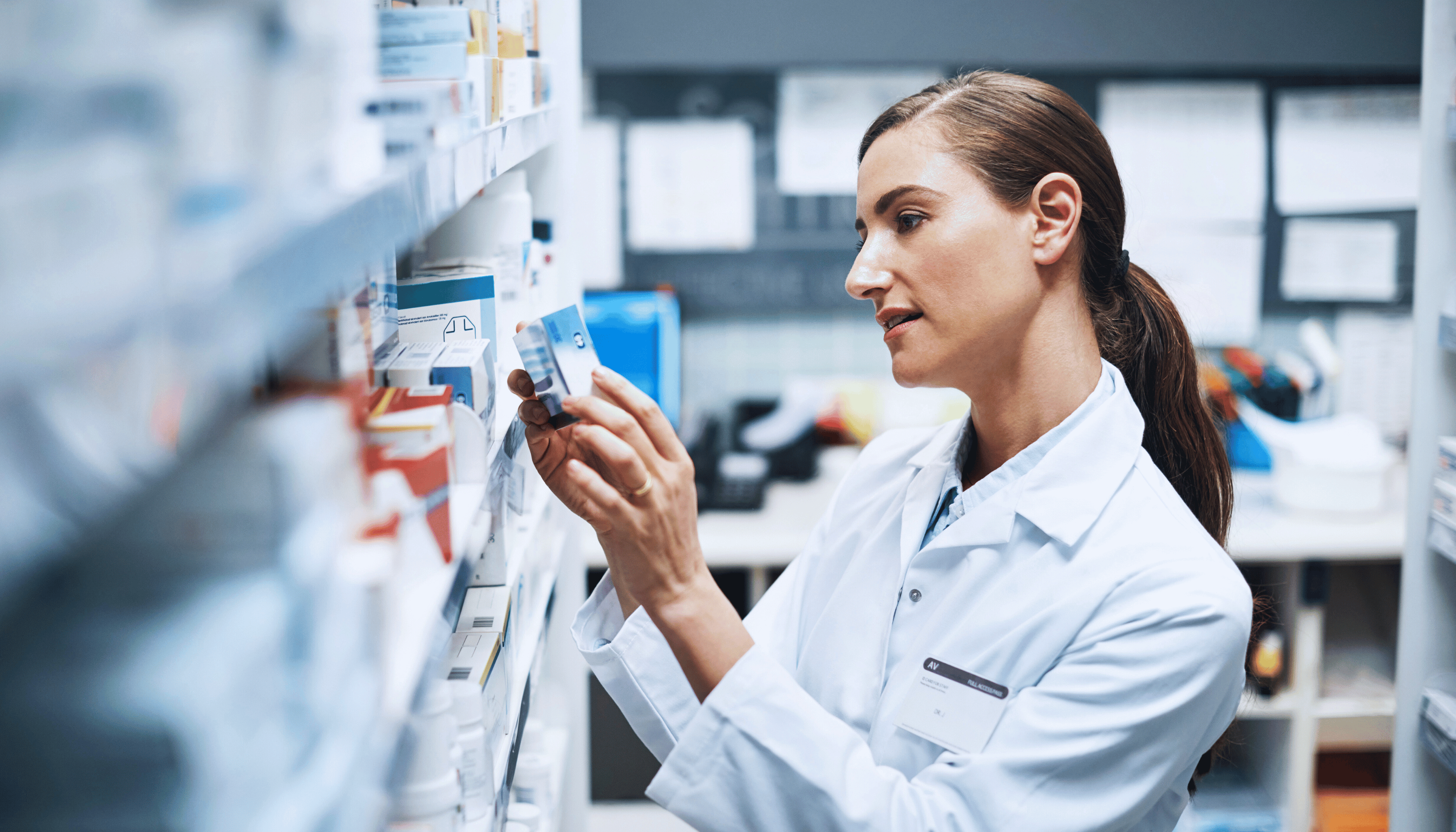 Pharmacist reviewing medication on a shelf, representing the safety protocols in clinical trials.