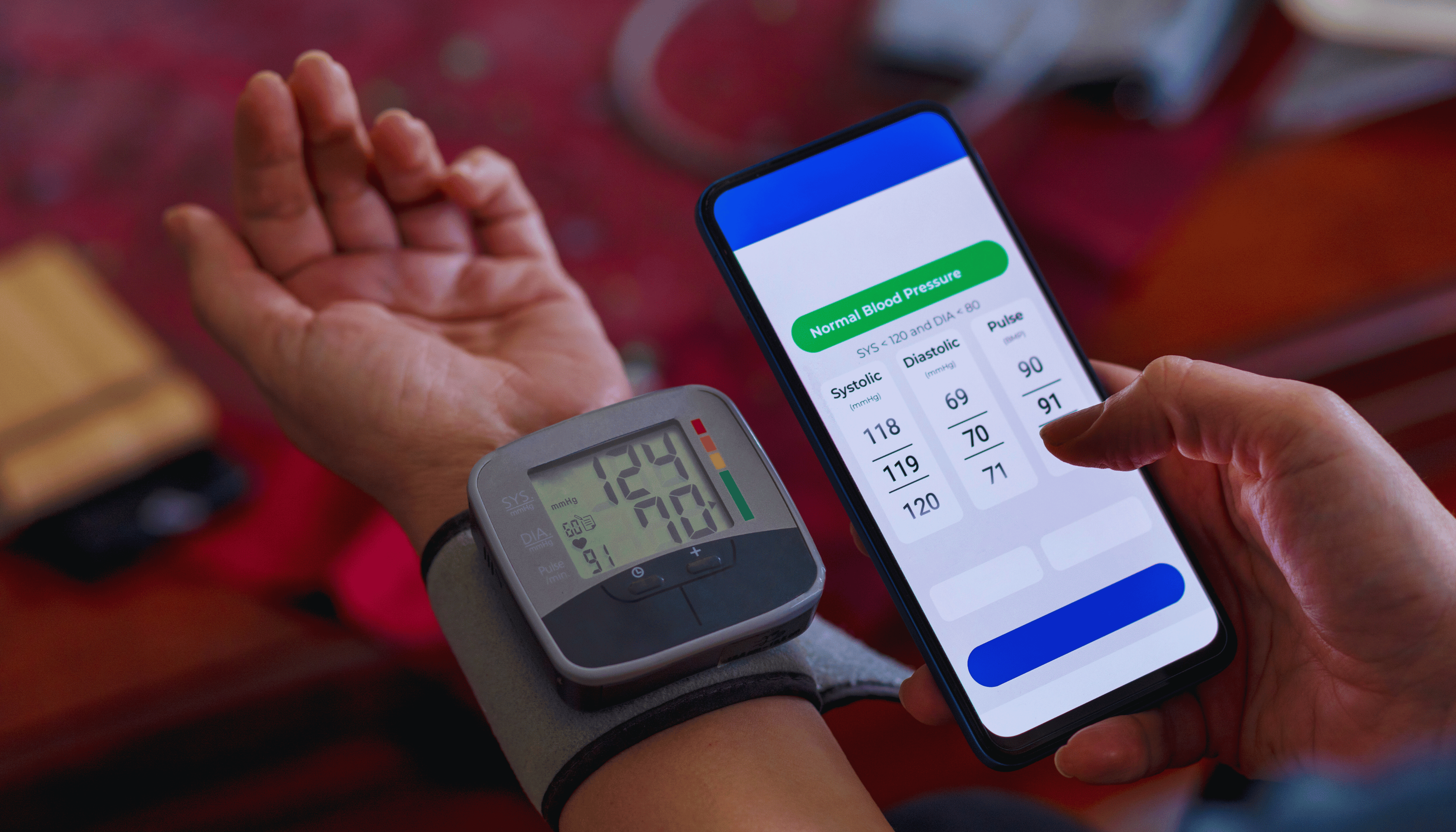 Person using a mobile app to monitor blood pressure, demonstrating the concept of decentralized clinical trials with remote health monitoring.