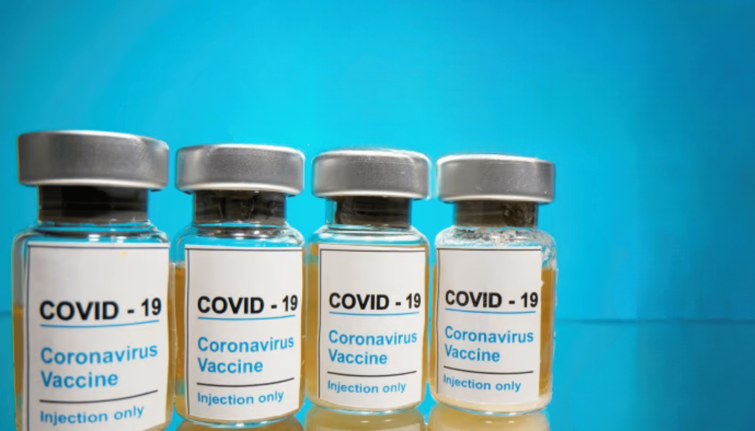 Multiple COVID-19 vaccine vials against a blue background, highlighting global vaccination efforts and research progress