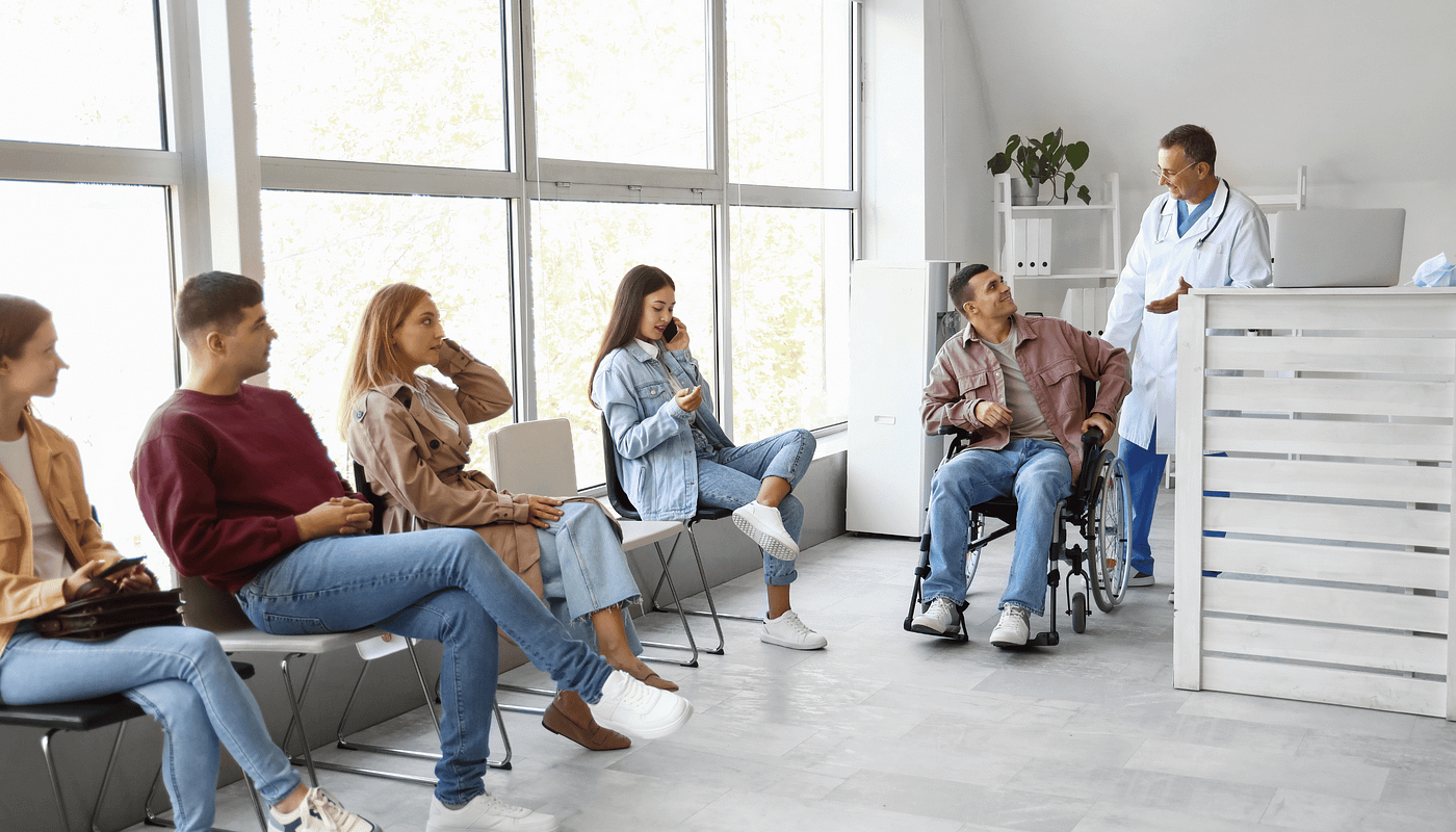 I group of people including Sarah waiting to be seen in a clinical trial centre.